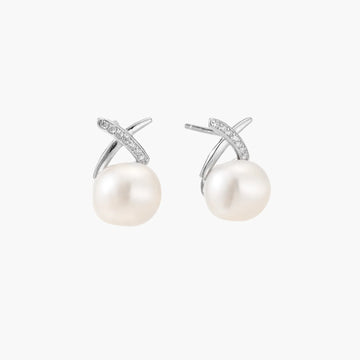 Rhodium-plated silver stud earrings with sparkling X design above lustrous round freshwater pearls on white background.