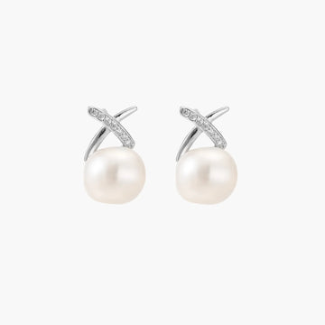 Rhodium-plated silver stud earrings with sparkling X design above lustrous round freshwater pearls on white background.