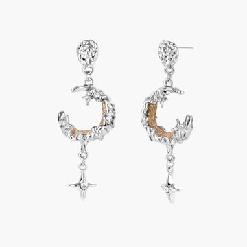 Detailed eco-brass dangle earrings featuring crescent moons with gold rope details and dangling star charms on white background.